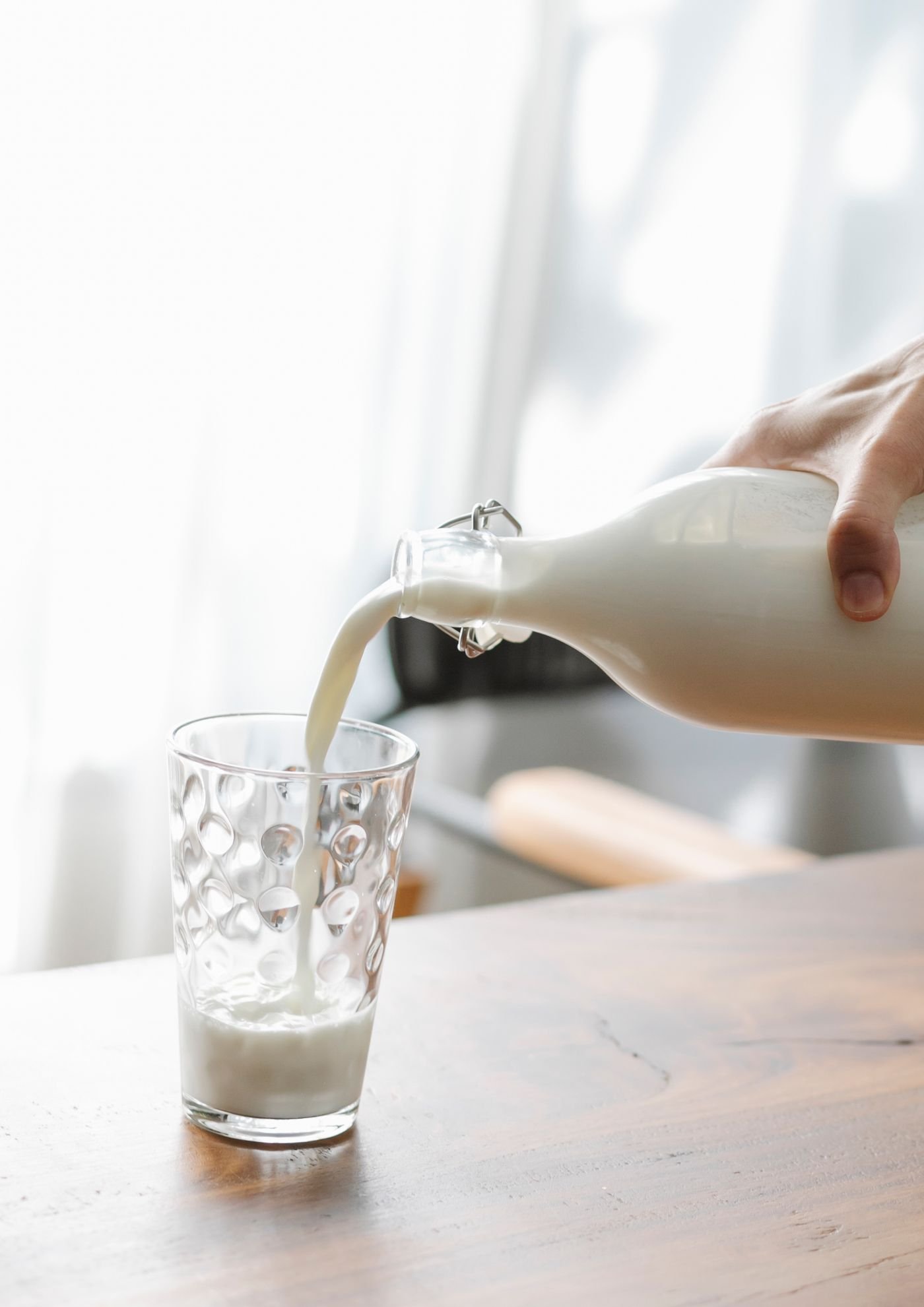 Milk being poured into a glass — a classic source of dietary calcium